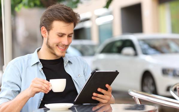 Man reading emails on tablet
