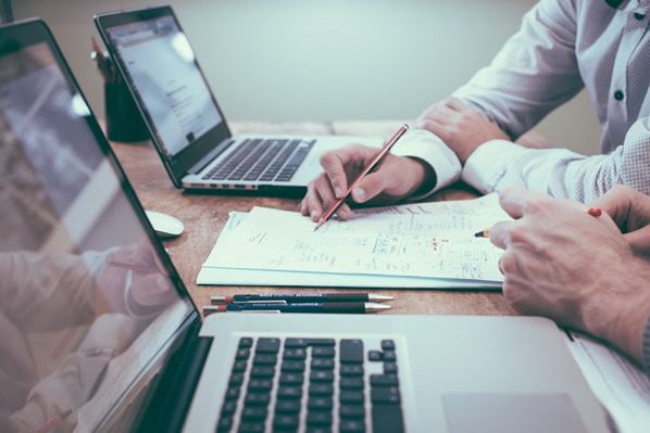 Accountants writing in a notebook 