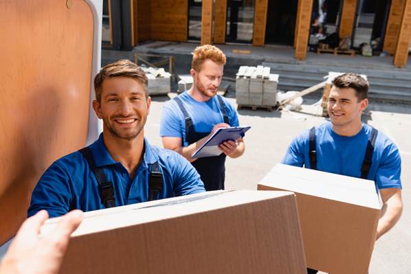 Warehouse employees loading truck with boxes