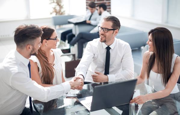 Recruitment manager shaking hands with new employees