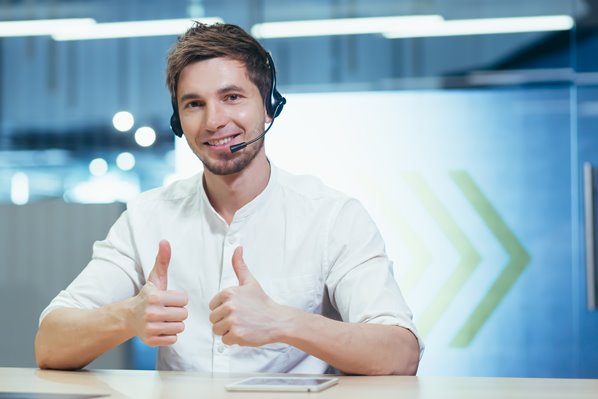 Smiling customer service representative with thumbs up