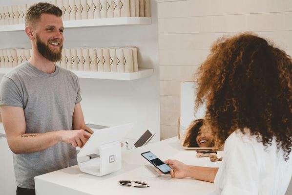 Shop assistant processing returned goods