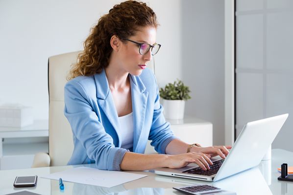 Customer service manager working on laptop