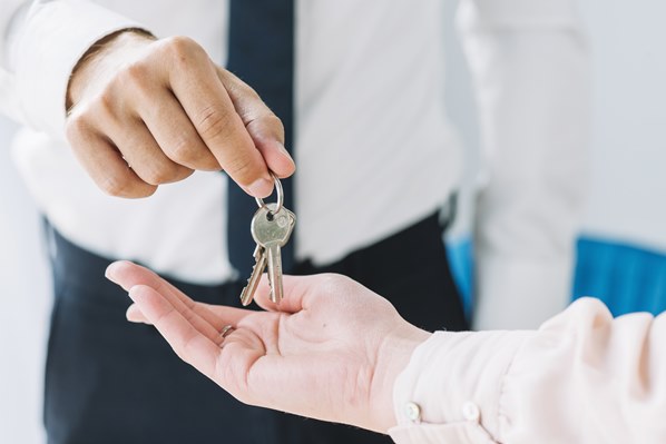 Real estate agent handing over keys to customer