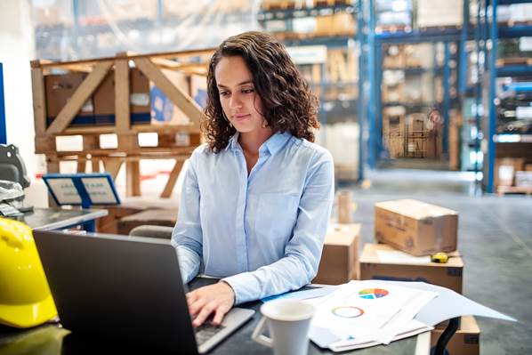 Warehouse manager using laptop