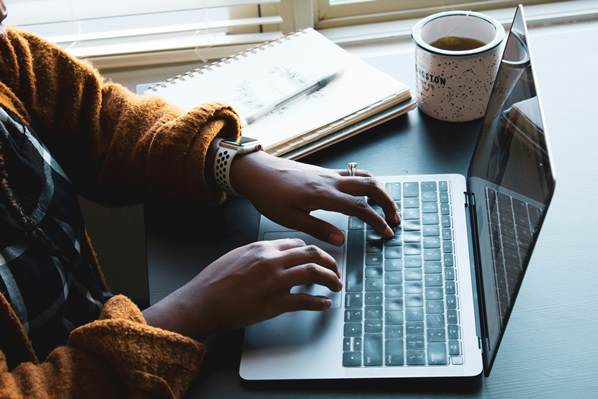 Student typing on her laptop