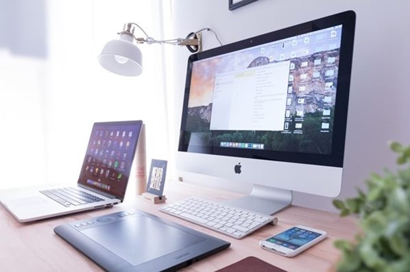 Computer and laptop on a desk