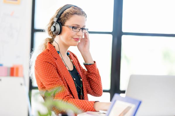 Women taking online course wearing headphones