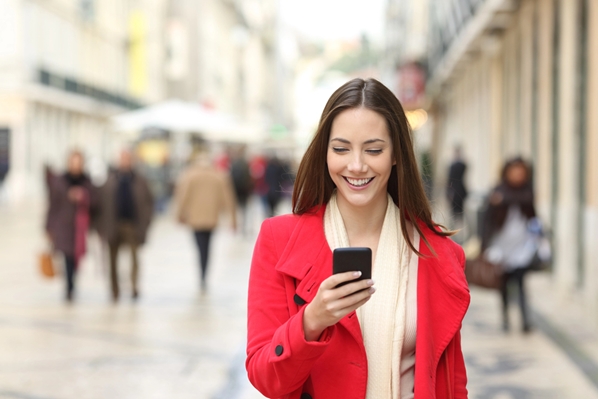 Customer looking at mobile phone in high street