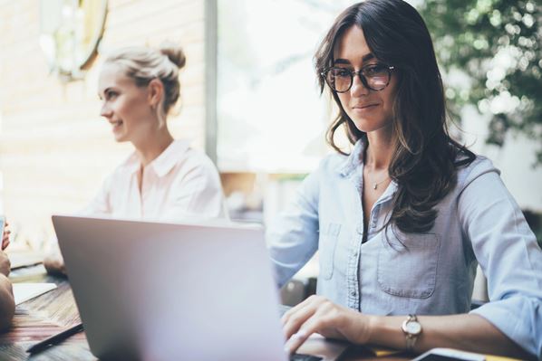 Salon manager using laptop