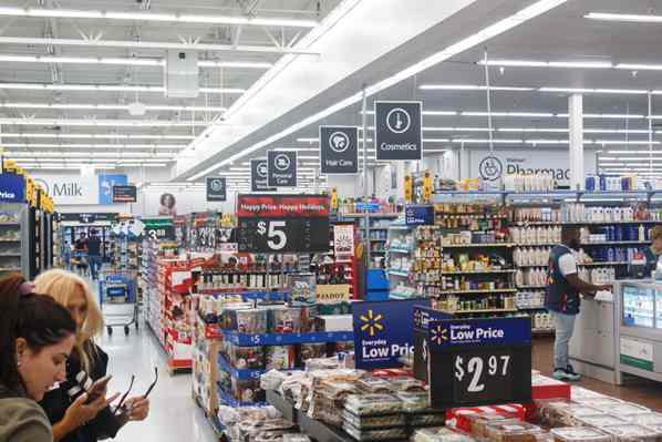 Inside Walmart store showing product price signs