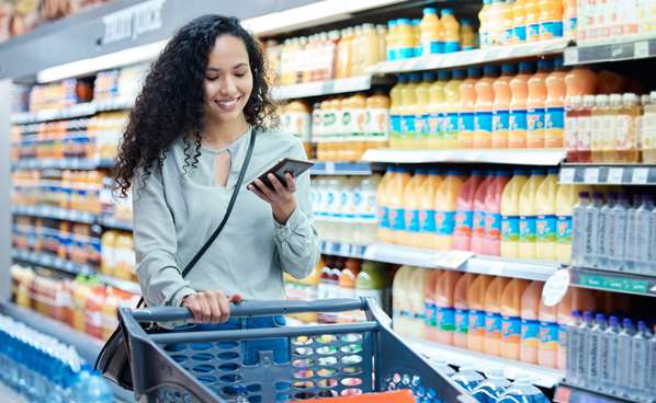 Women shopping in supermarket using her mobile phone