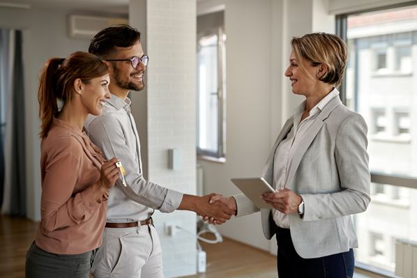 Realtor shaking hands with clients