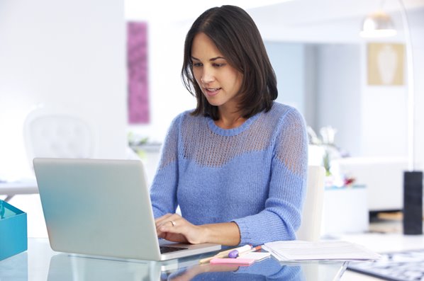 Women writing on her laptop