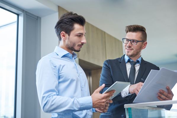 Operations managers discussing a report