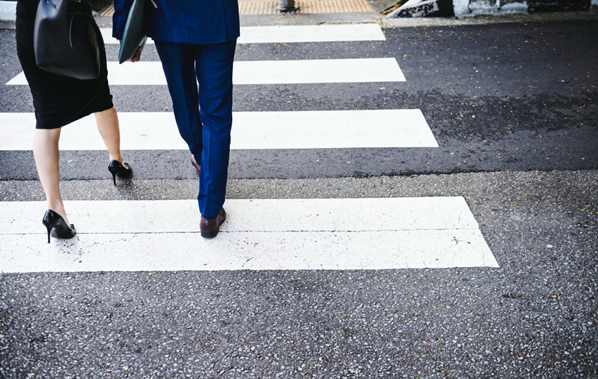 Two people crossing the street