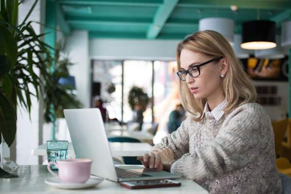 Women wearing glasses working on her laptop