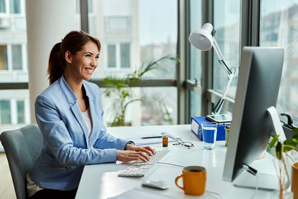 Customer success manager working on her computer in the office