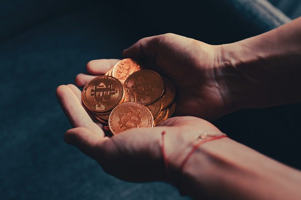 Cryptocurrency coins in hands