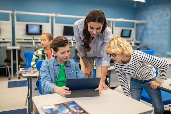 Teacher and students in a clasrrom using a computer