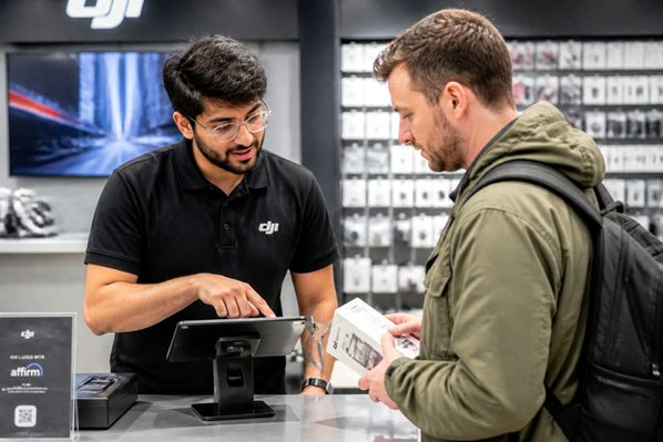 A helpful store assistant anticipating a customer's needs