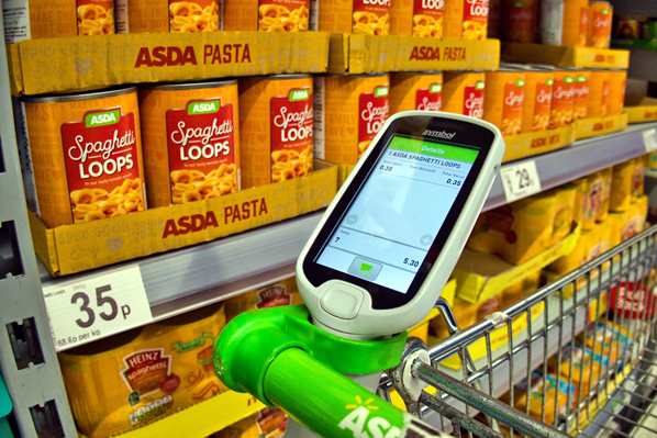 A self-scanning machine on a shopping trolly in a modern supermarket